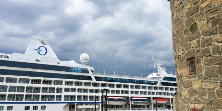 a large cruise ship in front of a stone building