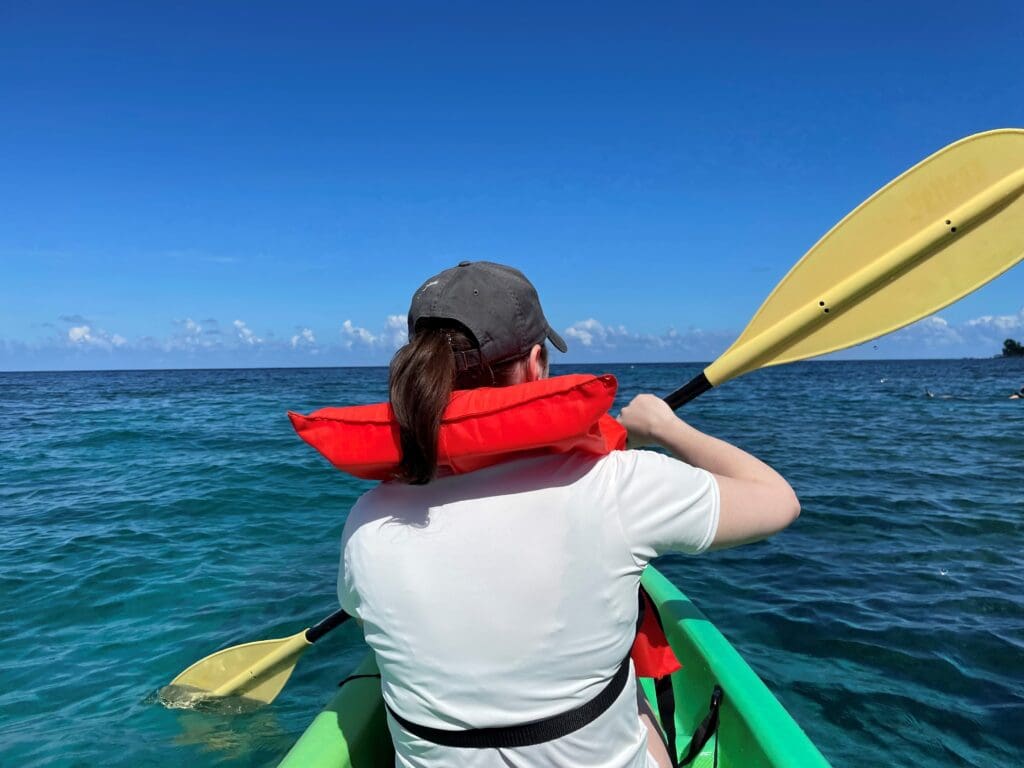 a person in a boat with a life jacket on