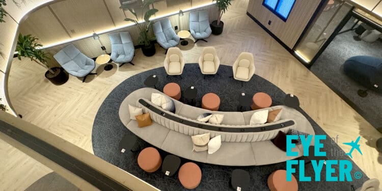 a room with a round couch and chairs