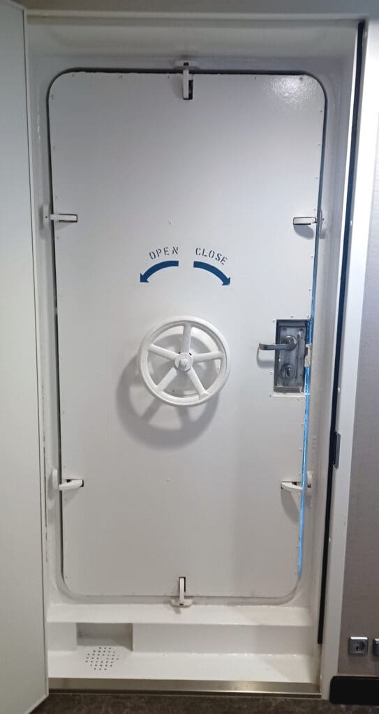 a white door with a wheel on it