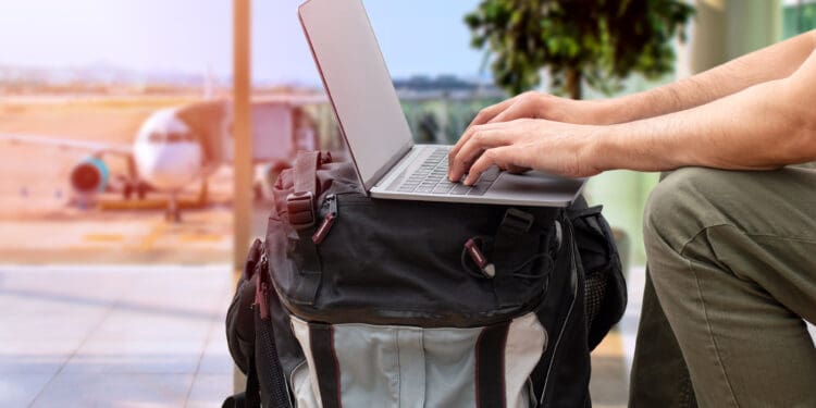 a person using a laptop on a backpack