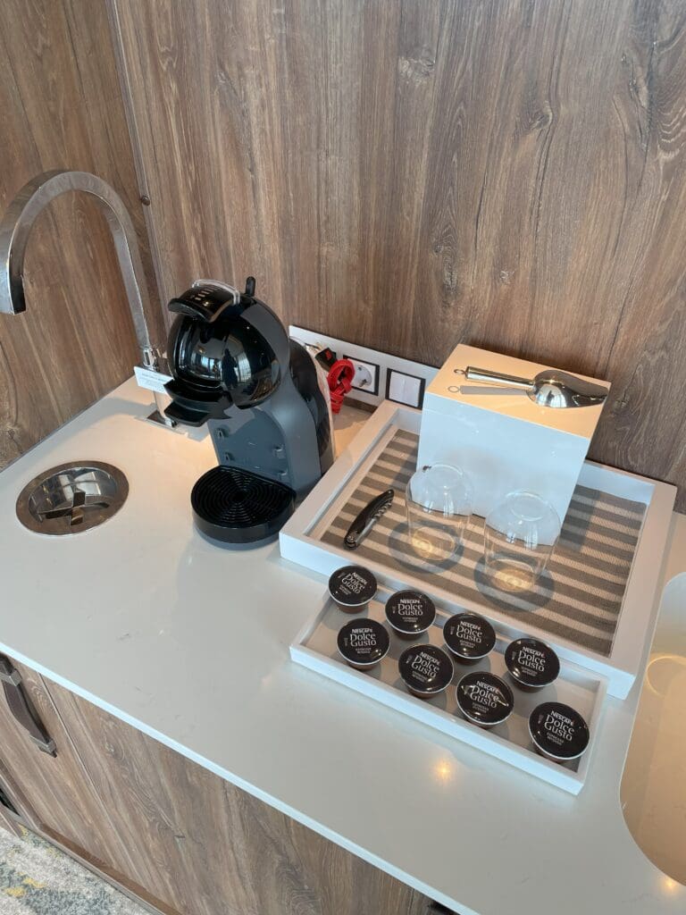 a coffee machine and cups on a counter