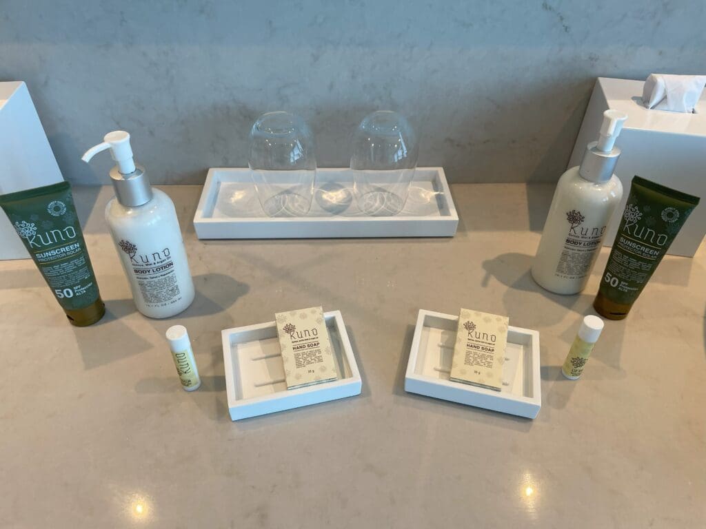 a group of white bottles and glasses on a table