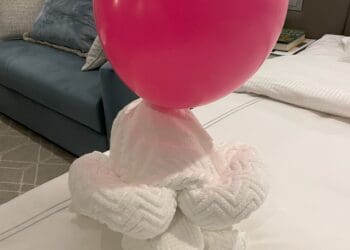 a pink balloon on a white towel