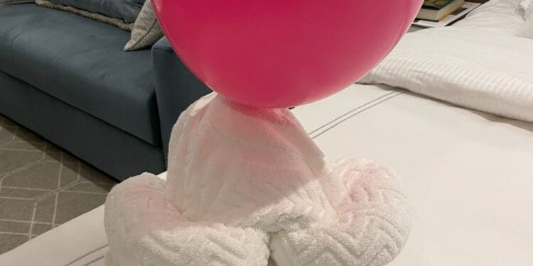 a pink balloon on a white towel