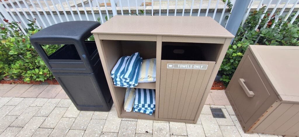 a brown cabinet with towels on it