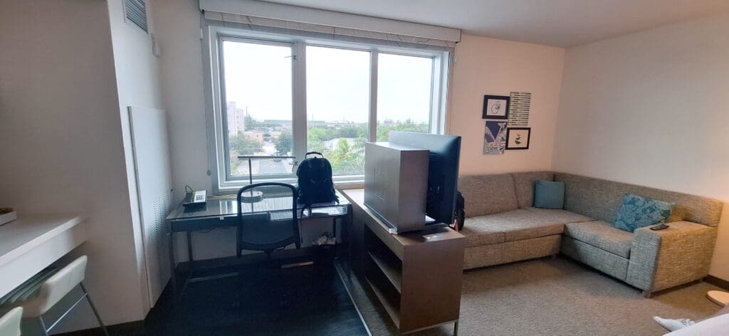 a room with a desk and a chair and a television