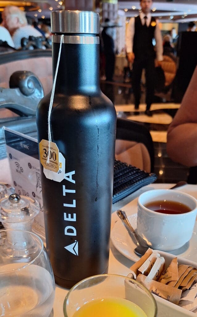 a black bottle of tea on a table