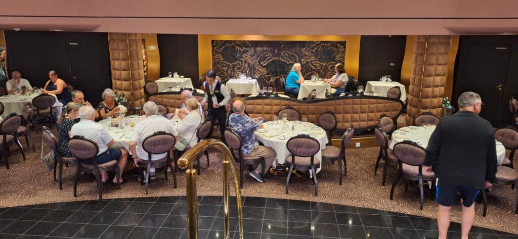 a group of people sitting at tables in a restaurant