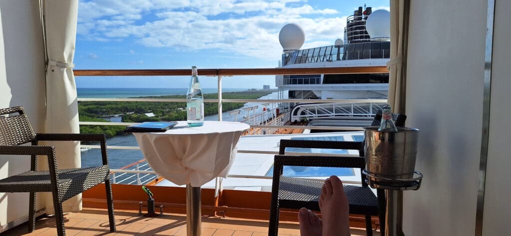 a person's feet on a deck overlooking a river