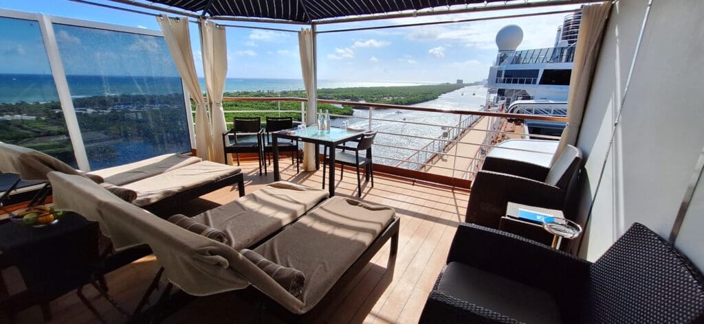 a deck with chairs and a view of the ocean