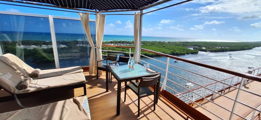 a table and chairs on a deck overlooking a body of water