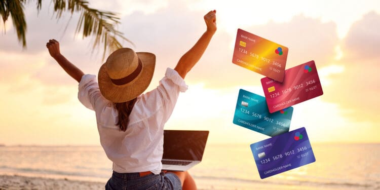 A woman and her laptop on a beach. Business credit card concept.
