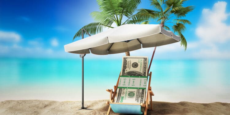 a beach chair under a umbrella with money on it