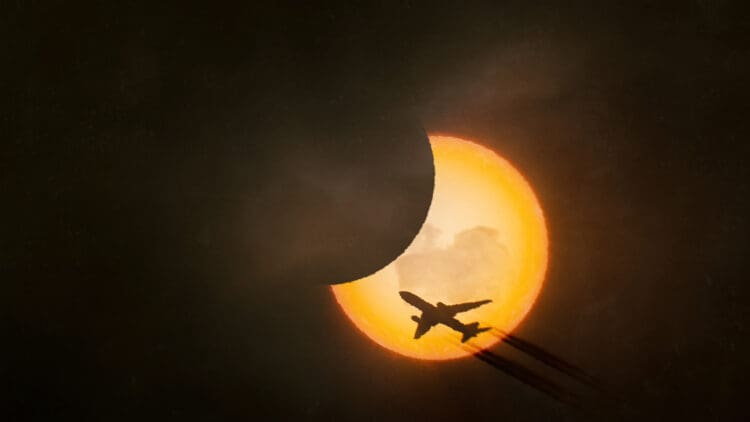 Solar eclipse with an airplane silhouette (©iStock.com/Daniel Christel)