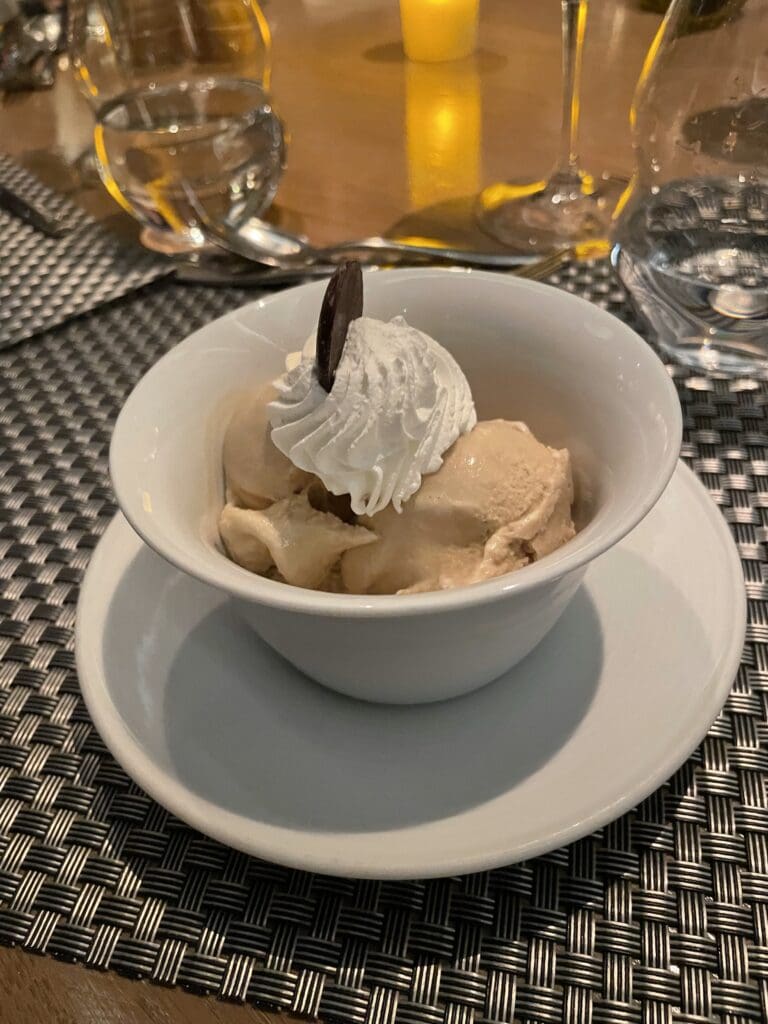 a bowl of ice cream with whipped cream on top