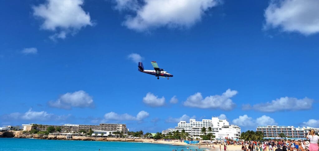 a plane flying over a beach