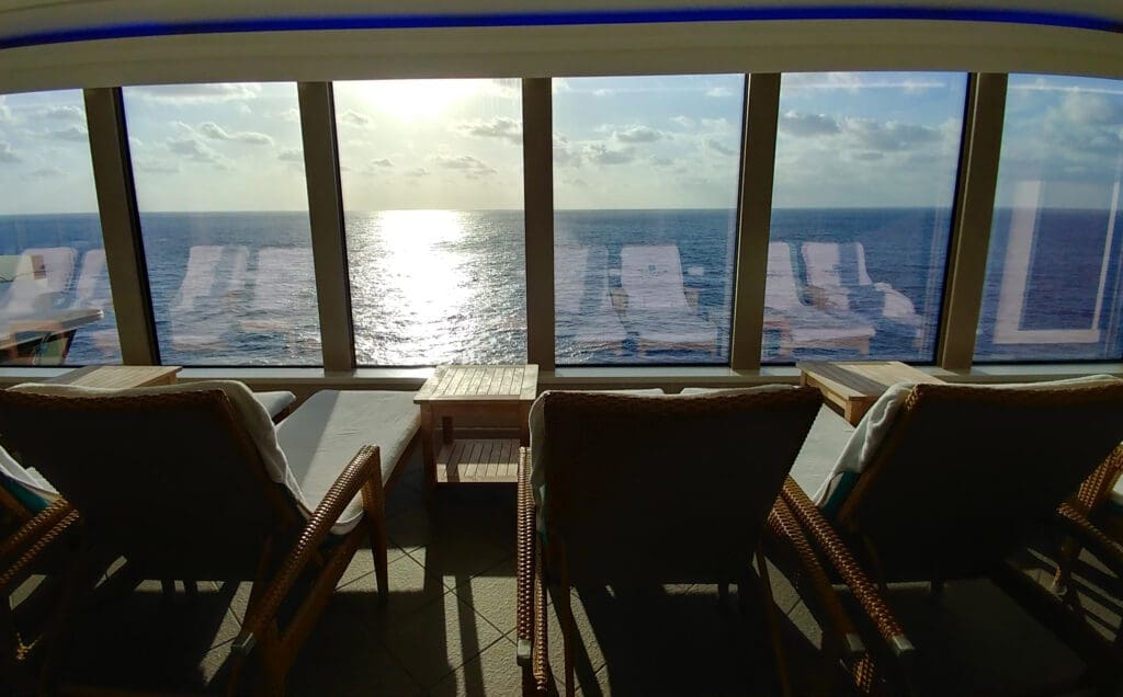 a room with chairs and a view of the ocean