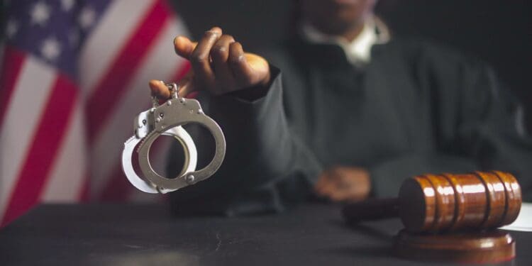 Judge showing handcuffs on camera, punishment for criminals, law