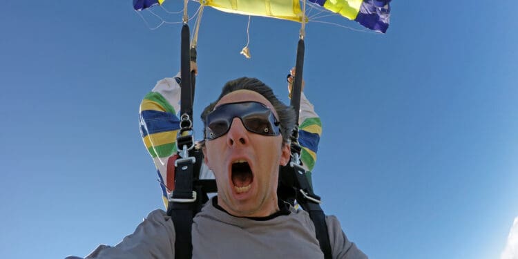 a man with his mouth open and a parachute