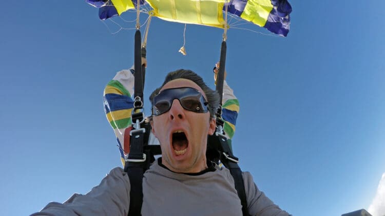 a man with his mouth open and a parachute