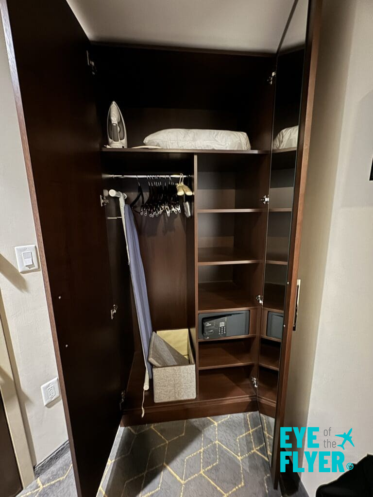 a closet with a towel and iron