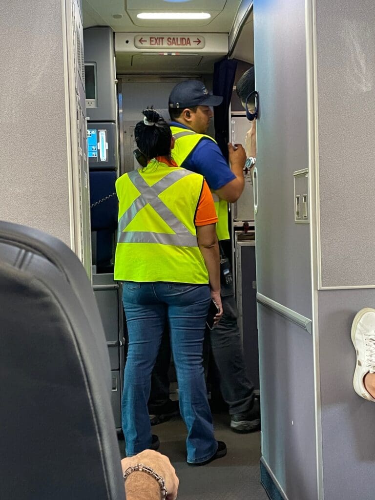 a man and woman in a yellow vest standing in a doorway