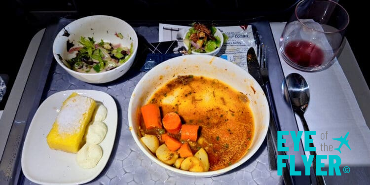 a bowl of soup and salad on a tray