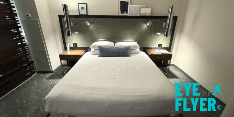 a bed with a headboard and lamps