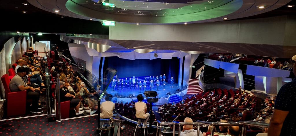 a group of people on a stage with a band on it