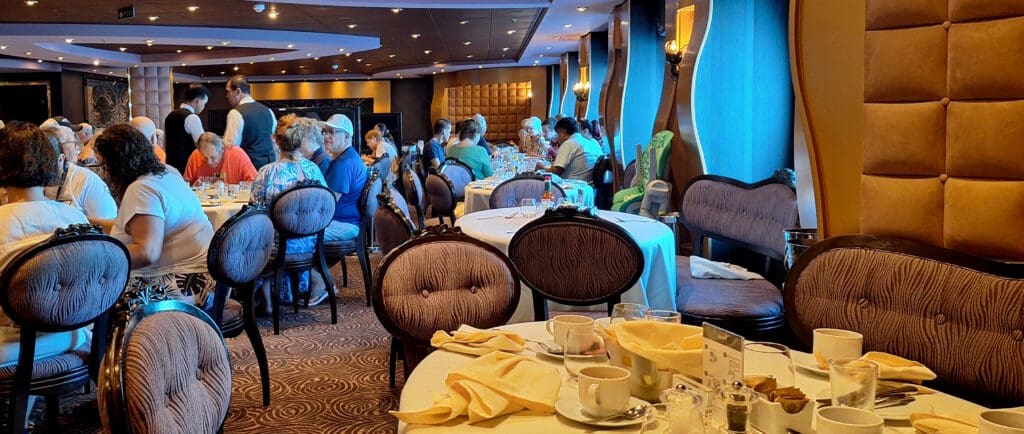 a group of people sitting at tables in a restaurant