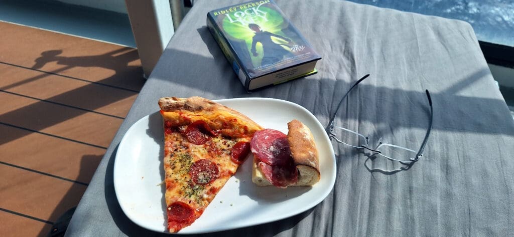 a plate of pizza and a book on a table