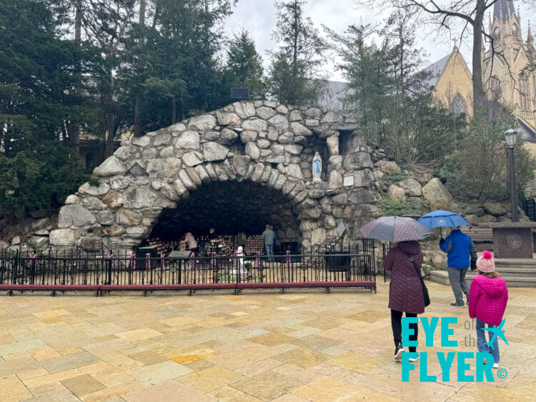 people walking in a stone tunnel