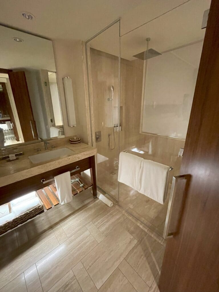 a bathroom with a glass shower and sink