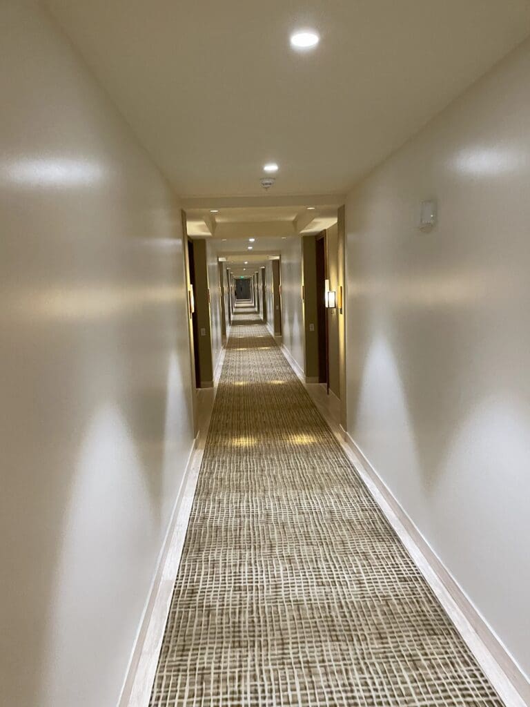 a long hallway with lights on