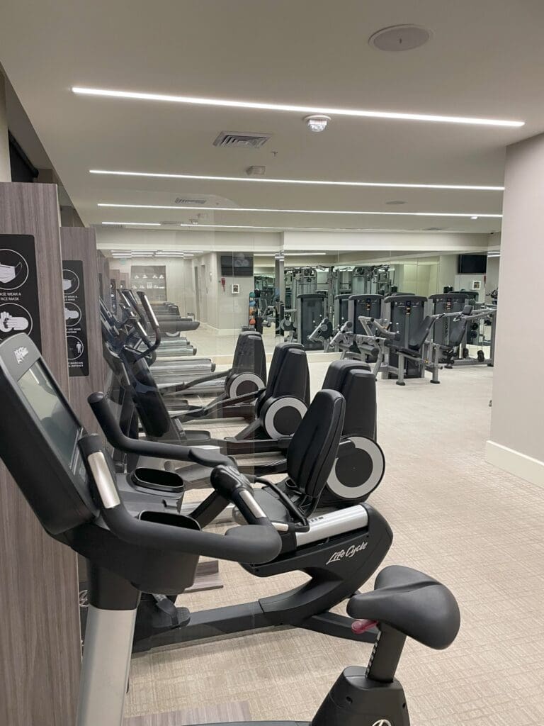 a room with exercise bikes and a mirror