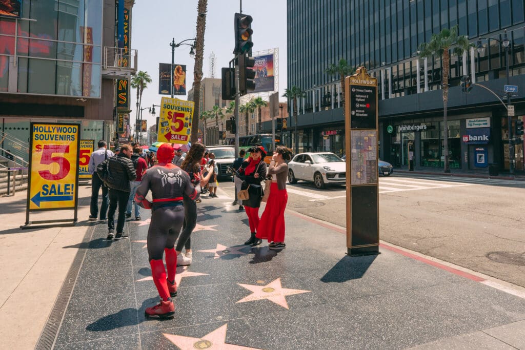 Los Angeles, California, USA - April 26, 2023. Crowded Hollywood Walk of Fame. Stars, street performances, and tourists. (©iStock.com/Nature, food, landscape, travel)