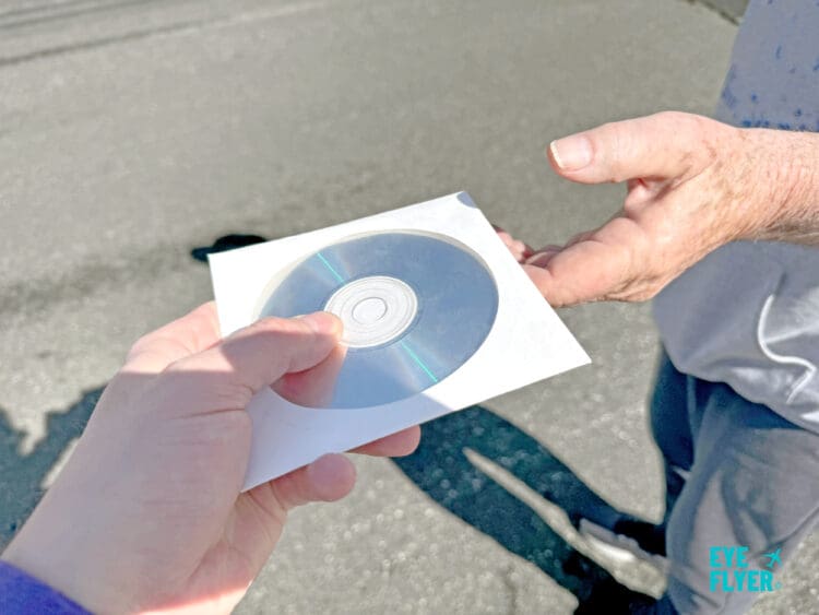 a person holding a cd in a square