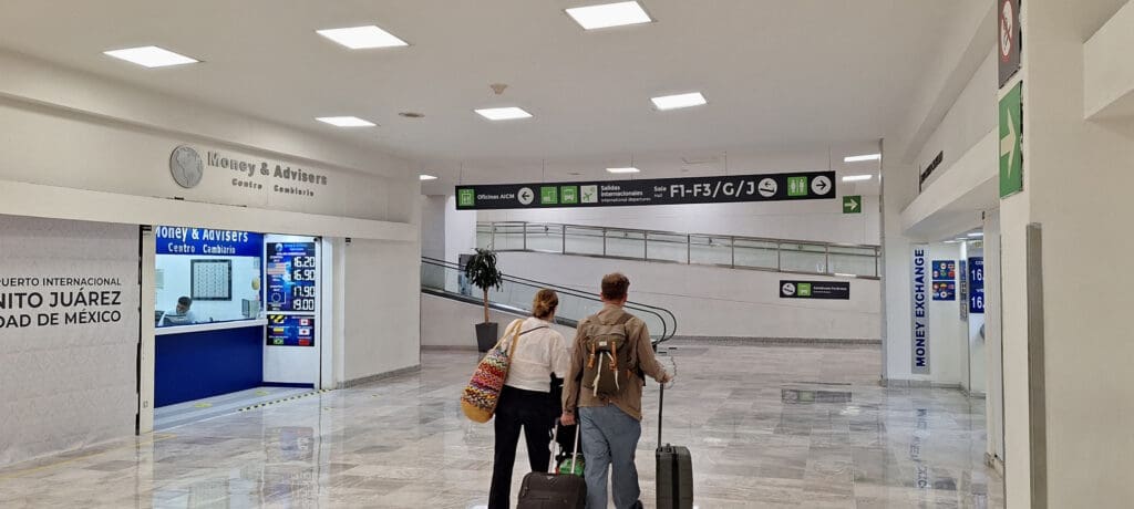 a man and woman with luggage in a building