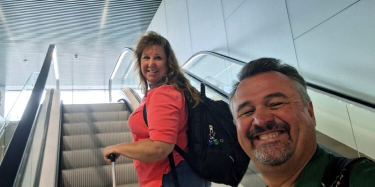 a man and woman standing on escalator