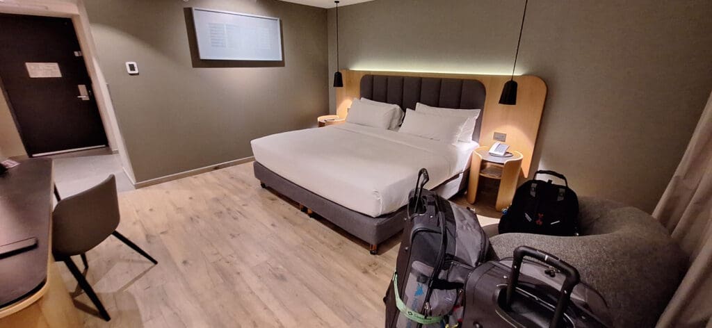 a hotel room with a bed and luggage