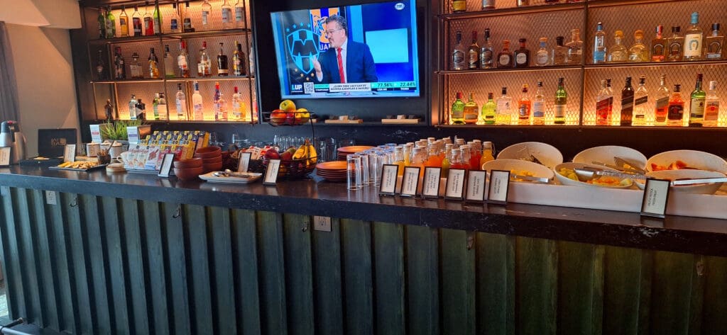 a bar with a television and bottles of alcohol