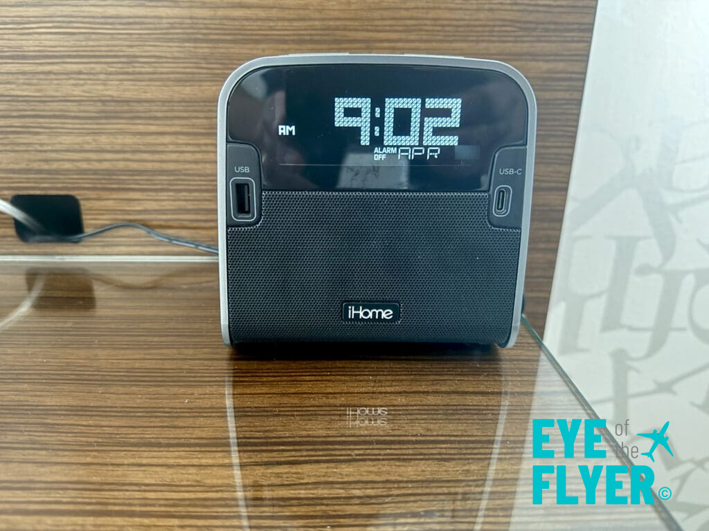 a black digital alarm clock on a table