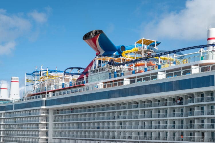 San Juan, Puerto Rico - Nov 22, 2023: Family cruise ship Carnival Celebration with roller coaster and water park docked in port of San Juan, Puerto Rico. Close-up. Side view