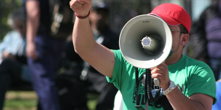 Protester pointing finger and holding megaphone