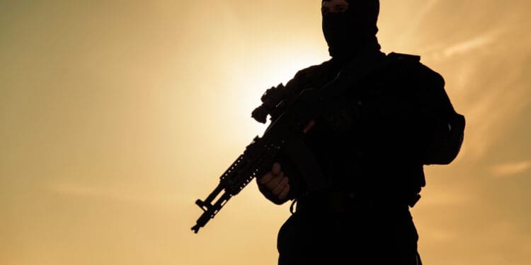 a man in black mask holding a gun