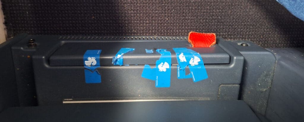 a blue stickers on a metal surface