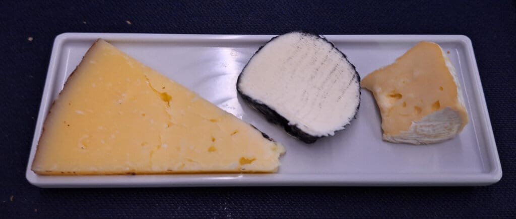 a plate of cheese and a slice of cheese