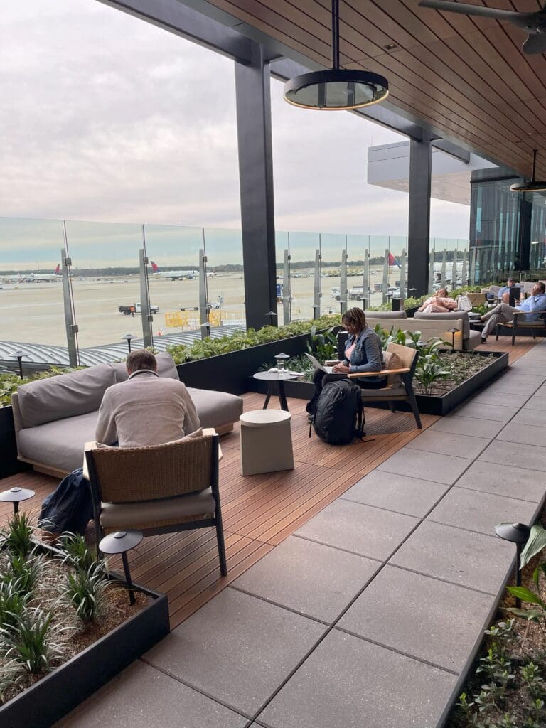 people sitting on a patio with a couple of people on it