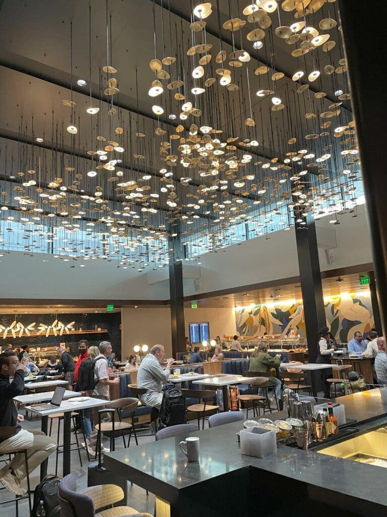 a group of people sitting at tables in a restaurant